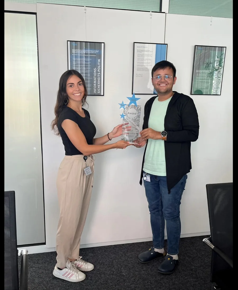 Kapil receiving a project innovation award at Flex alongside a colleague